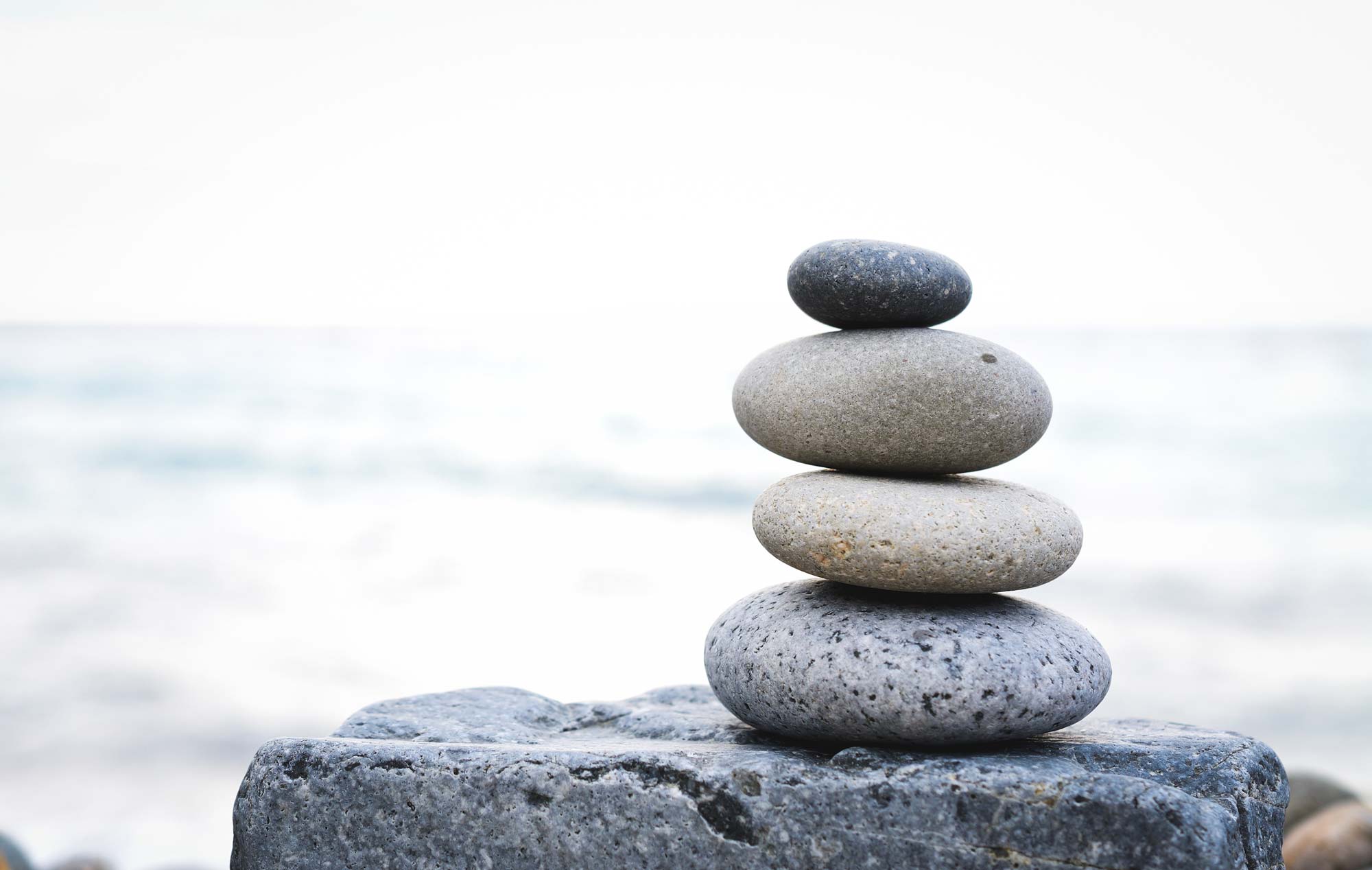 Stones-stacked-in-front-of-water