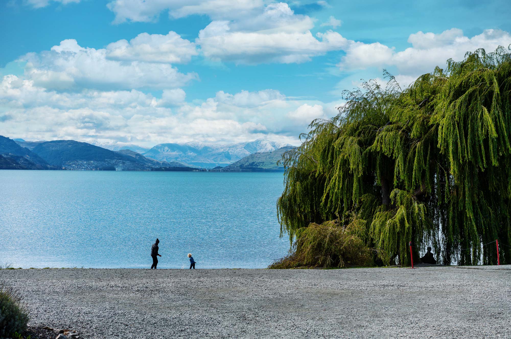 family-skipping-stones-at-lake