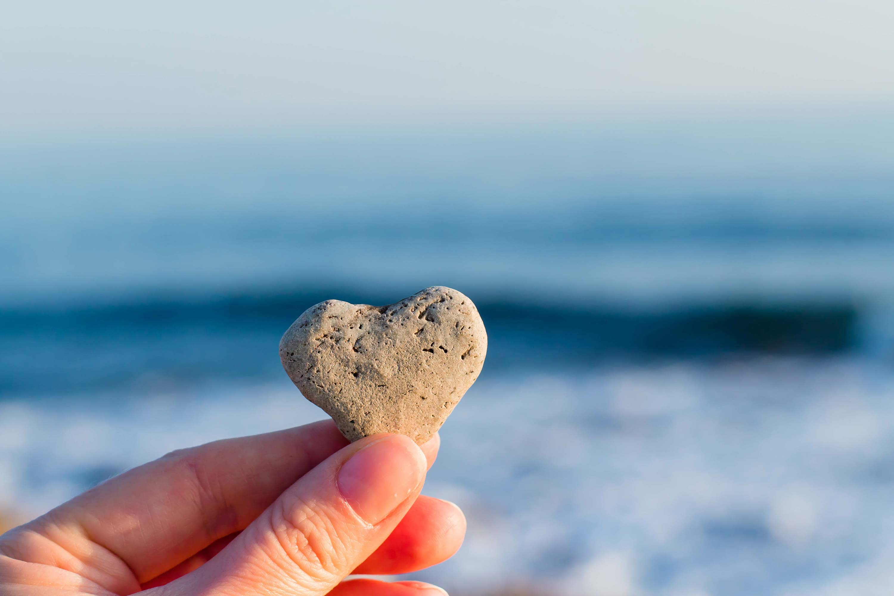 person-holding-a-heart-shaped-rock